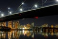 Dark cityscape with bridge, reflection on