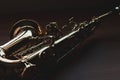 Dark closeup of saxophone on a wood surface Royalty Free Stock Photo