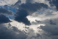 DARK CLOUD DRIFTING PAST WHITE CLOUDS IN BLUE SKY Royalty Free Stock Photo