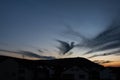 Dark cloud in shape of a pigeon in the evening sky Royalty Free Stock Photo