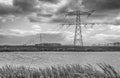 Dark clouds above a row of power pylons Royalty Free Stock Photo