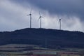 Dark clouds behind wind turbines Royalty Free Stock Photo