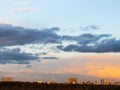 Dark clouds in blue sky over houses at sunset Royalty Free Stock Photo