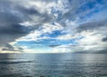 Dark Clouds in Blue Sky Over Open Ocean Royalty Free Stock Photo