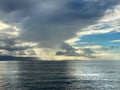 Dark Clouds in Blue Sky Over Open Ocean Royalty Free Stock Photo