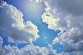 Dark clouds on blue sky with sunlight and flare. Royalty Free Stock Photo