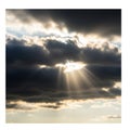 Dark clouds dominate the sky, with sunlight piercing through, creating dramatic Royalty Free Stock Photo