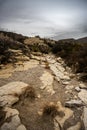 Dark Clouds Hang Over Rocky Dry Wash Royalty Free Stock Photo