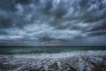 Dark clouds, heavy rain and waves on a stormy sea Royalty Free Stock Photo