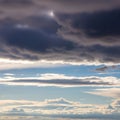 Upper cloud layer and the scattered brighter clouds below creates Royalty Free Stock Photo