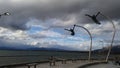 Dark clouds monument sculrpture man woman ocean Royalty Free Stock Photo