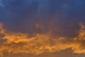 Dark clouds with orange glow at sunset Royalty Free Stock Photo