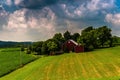 Dark clouds over a barn and farm fields in rural Southern York C Royalty Free Stock Photo