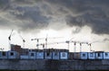 Dark clouds over the construction site and construction cranes Royalty Free Stock Photo