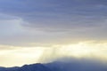 Dark clouds raining over mountain range and valley in Mojave Desert, USA Royalty Free Stock Photo