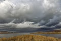 Dark clouds river island. Royalty Free Stock Photo