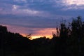 Dark clouds at sunrise over trees. Beautifu landscape sunset in the summer Royalty Free Stock Photo