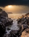 Dark Clouds at Sunset hanging over the Pacific Ocean at a Gap in the rocky shore between Cox Bay and Chesterman Beach Royalty Free Stock Photo