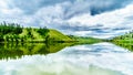 Dark Clouds and surrounding Mountains reflecting on the smooth water surface of Trapp Lake Royalty Free Stock Photo