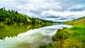 Dark Clouds and surrounding Mountains reflecting on the smooth water surface of Trapp Lake Royalty Free Stock Photo