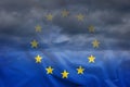 Dark clouds viewed through EU flag Royalty Free Stock Photo