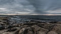 Dark clouds and wild rocks at the coastline of the Baltic Sea Royalty Free Stock Photo