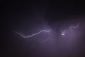 Dark cloudy sky with a dramatic thunder storm and striking single lightning bolt strike Royalty Free Stock Photo