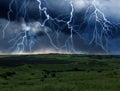 Dark cloudy sky with lightnings. Picturesque thunderstorm over field Royalty Free Stock Photo