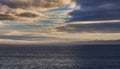 Dark cloudy sky at sunset over the ocean Royalty Free Stock Photo