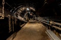 Dark coal mine tunnel with minimal light, showing deep stope and active coal extraction. Royalty Free Stock Photo