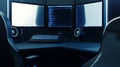 Dark coding workspace with multiple monitors and gaming chair setup home office environment for software development programmers Royalty Free Stock Photo