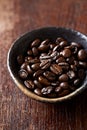 Dark coffee beans in a ceramic dish Royalty Free Stock Photo