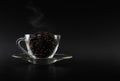 Dark coffee beans on glass cup