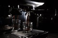 Dark coffee drops dripping in a transparent glass espresso cup on a manual espresso machine with copy space, close up