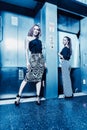 Dark color toned picture of two fashionable girl in the elevator. Royalty Free Stock Photo