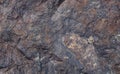 Dark colored natural hill stone texture background. Royalty Free Stock Photo