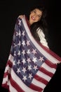 Dark complected pretty woman holding American flag scarf