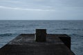 Dark concept of abandoned chair in stormy Ocean
