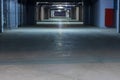 Dark coridor in underground parking garage with separate boxes, view on the way out Royalty Free Stock Photo