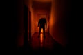 Dark corridor with cabinet doors and lights with silhouette of spooky horror man standing with different poses. Royalty Free Stock Photo