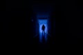 Dark corridor with cabinet doors and lights with silhouette of spooky horror man standing with different poses. Royalty Free Stock Photo