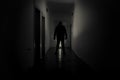 Dark corridor with cabinet doors and lights with silhouette of spooky horror man standing with different poses. Royalty Free Stock Photo