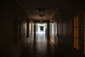 A Dark corridor in the hospital. A long terrible corridor with light from the windows. Scary way Royalty Free Stock Photo