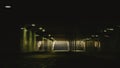 Staircase in a dark underground passage with light at the end