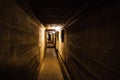 Dark corridor of old underground Soviet military bunker under artillery fortification.