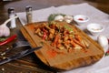 On a dark countertop, a light linen napkin, on a cutting board Seafood Squid in batter with sauce and spices on a board on a dark Royalty Free Stock Photo