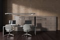 Dark coworking office interior with pc computer, brown shelves on hardwood floor Royalty Free Stock Photo