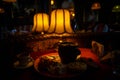 Dark and cozy interior of a Georgian restaurant with yellow lampshade and lamps.