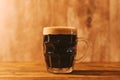 Dark craft beer in british dimpled glass pint mug