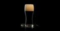 Dark craft beer with foam brewed from malt and barley in a private brewery on a black background for the festival Royalty Free Stock Photo